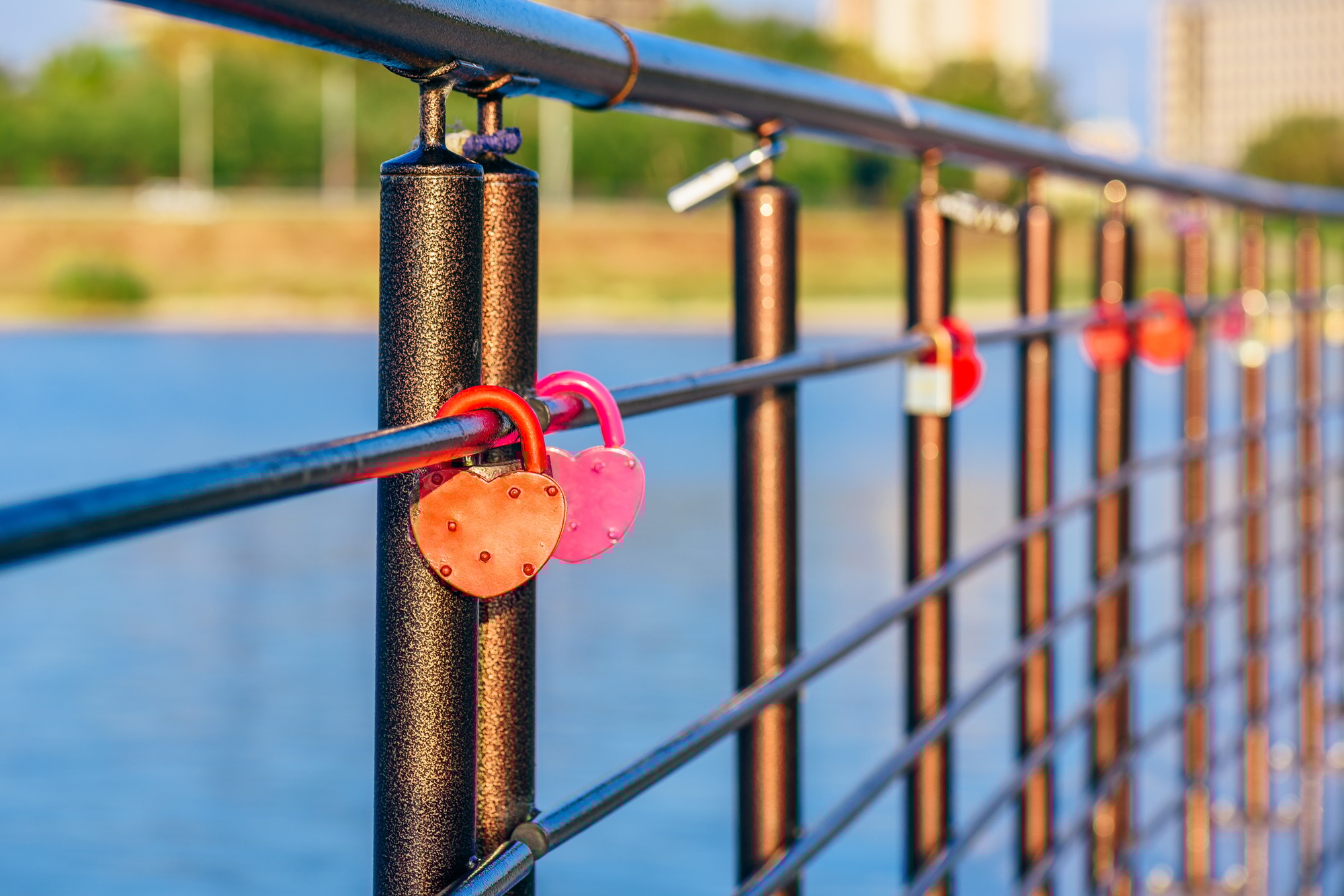 Metal locks hanging on railings.