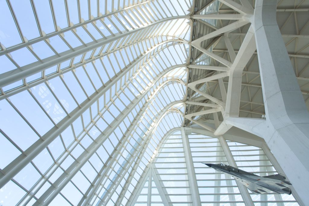 Modern architecture showcasing a sweeping glass canopy and intricate structure.