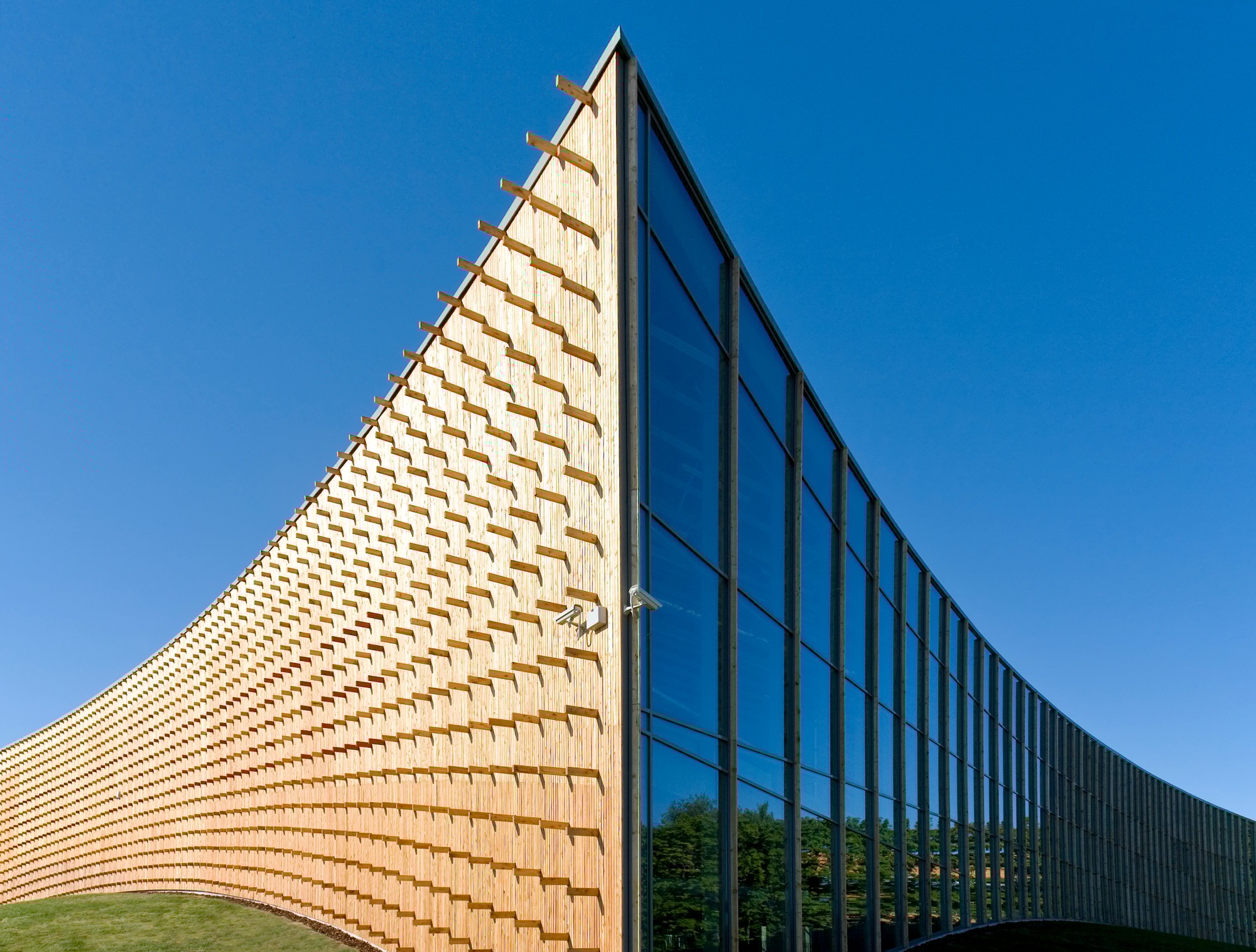 Modern university buildings, wooden beams projecting from a curved wood cladding