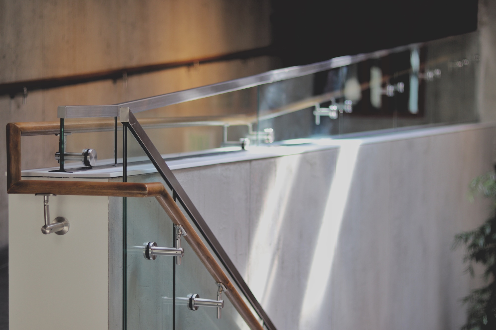 Wood, glass and steel railing on a concrete wall