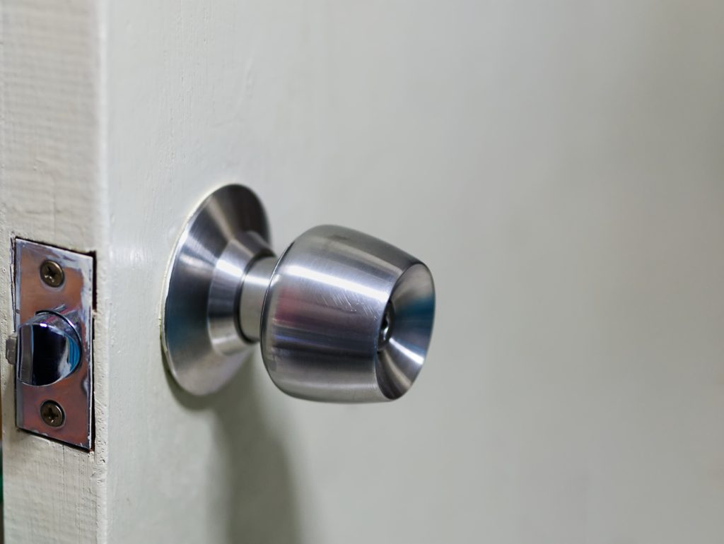Close-up Metallic Door Knob on Wooden Door